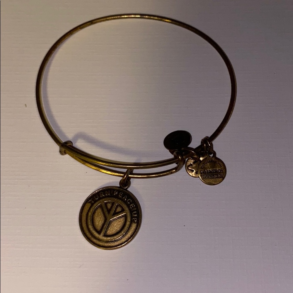 Gold Alex and Ani peace bracelet
